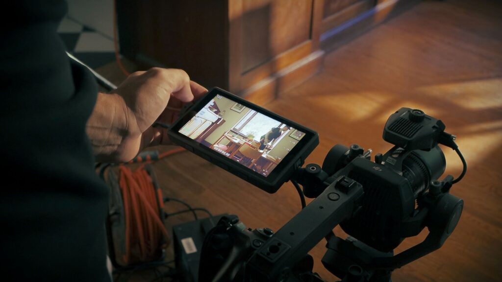 Images of a viewscreen attached to a DJI Ronin 4D camera as videographer adjusts settings